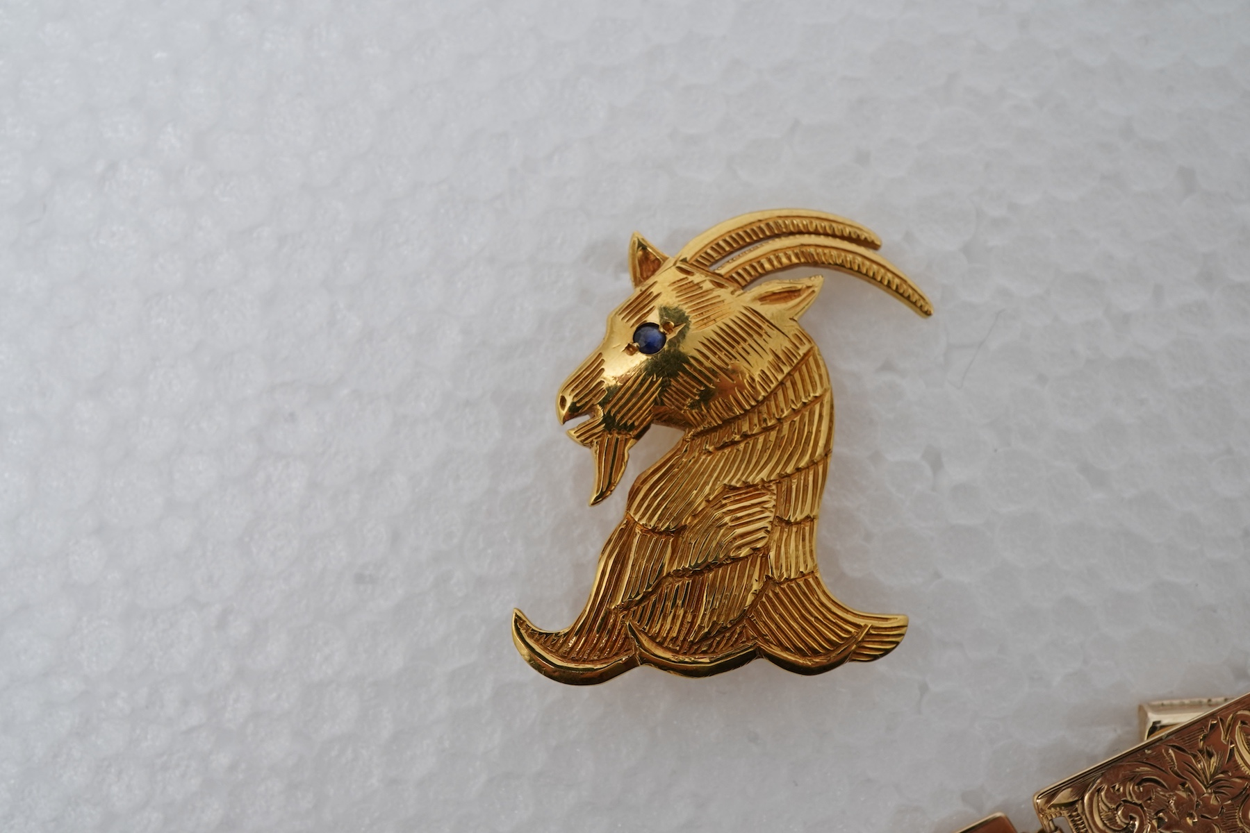 An 18ct gold livery brooch and a gold panel bracelet